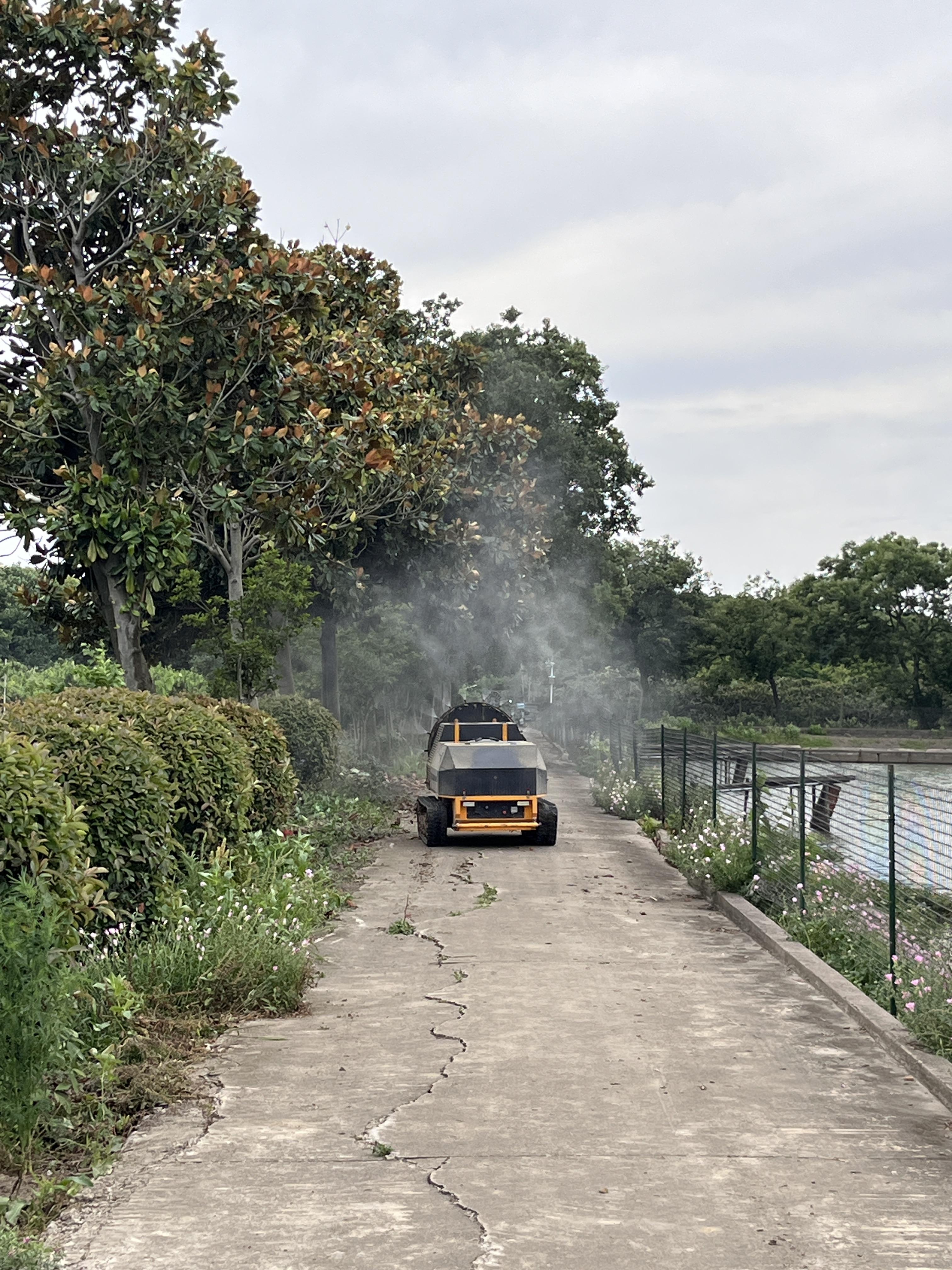 Remote crawler sprayer operating in an orchard path